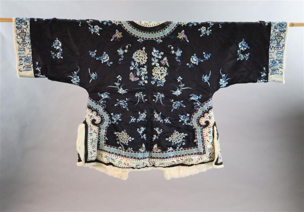 A Chinese black silk multi-coloured embroidered three quarter length winter jacket, late 19th century/early 20th century, length 90cm